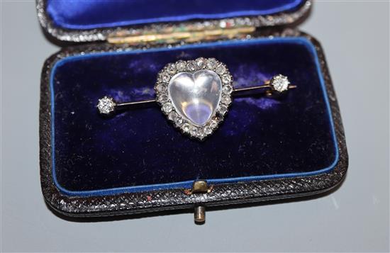 A diamond and moonstone bar brooch, heart-shaped setting in yellow metal (one stone missing), boxed 40mm.